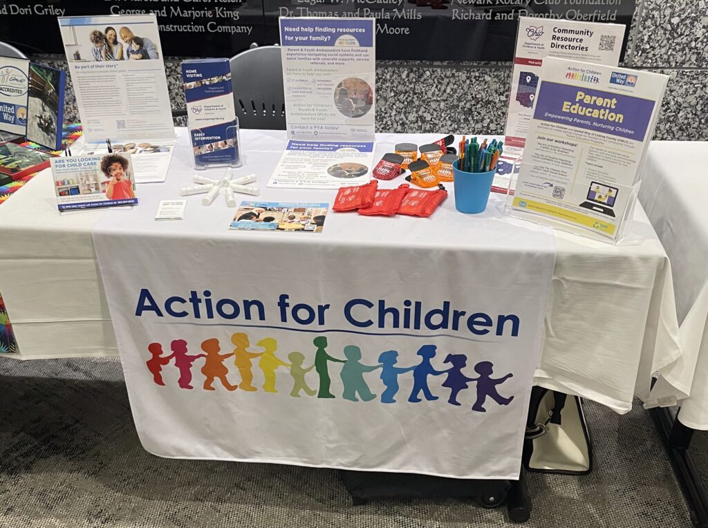 Action for Children table with collaborative outreach materials and TAPP information at a United Way of Licking County event.