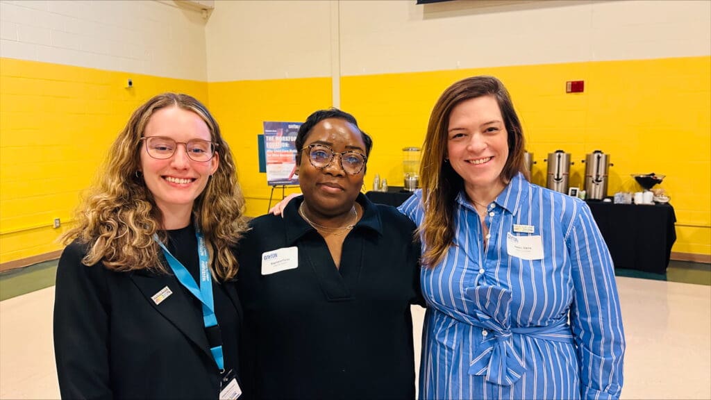 Three Action for Children team members at a community event promoting Early Care and Education Business Partnerships.